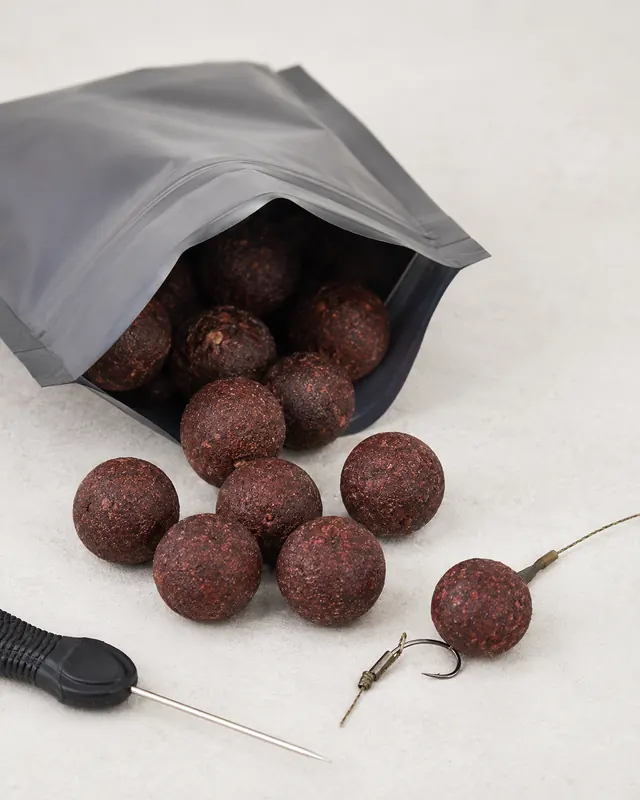 Dark boilies with a carp fishing hair rig
